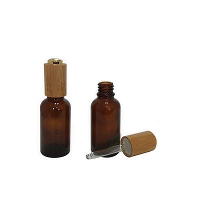 De Fles van de glasetherische olie met het Bamboedoos Veilig voor kinderen van het Bamboedruppelbuisje
